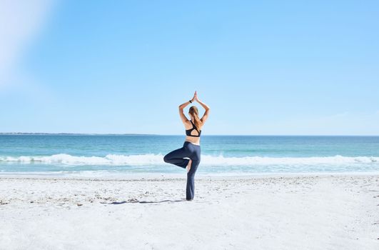 Yoga, woman and at beach on sand, meditation and relax for wellness, calm and peace. Zen, female and lady with balance, exercise and pilates for training, fitness or breathing on seaside and outdoor.
