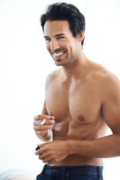 Cigarette break. Portrait of a bare-chested man about to light a cigarette isolated on white.