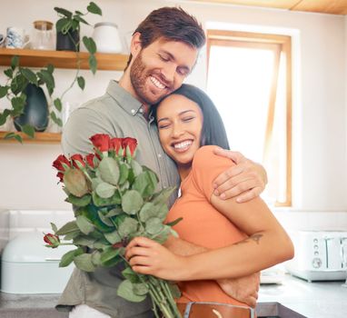 Young content caucasian boyfriend hugging his mixed race girlfriend after giving her a bouquet of flowers at home. Hispanic wife receiving roses from her husband. Interracial couple bonding together