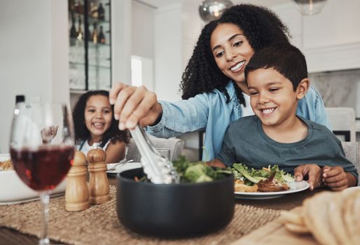 Mother, kids and eating food in home together for lunch, dinner table and healthy meal. Happy family, mom and children smile for dining in house with love, care and happiness of delicious supper.