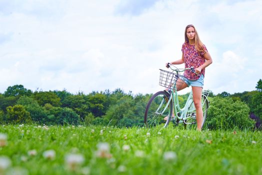 Getting to know Mother Nature on her bicycle. a young woman cycling in the countryside.