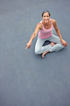 Find the peace you need. High angle portrait of an attractive mature woman in gymwear pointing at copyspace.