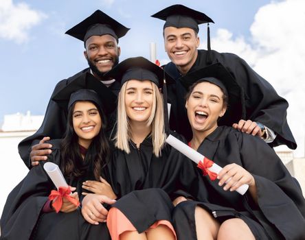 Graduation, student group and happy portrait for success, diversity and sky background. International graduates, friends and celebration of study goals, award and smile for college education event