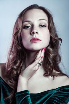 Confident beautiful woman in dress, having red manicure, looking at camera, expressing confidence.