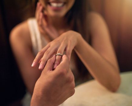 Engagement, proposal and woman hands with ring in restaurant for celebration, wedding and marriage. Love, valentines couple and man with diamond jewellery for girl for commitment, trust and romance