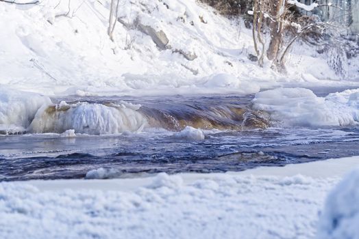 Arctic, Nordic landscape in winter time. Small river with ice in winter time