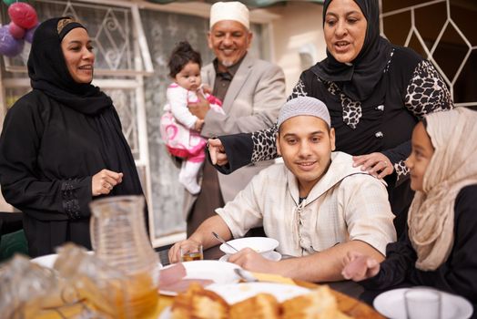 Ramadan is about eating together as a family. a muslim family eating together.