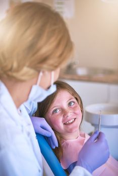 Your smile is in safe hands. a dentist examining a little girls teeth