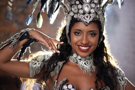 Glamourous dancing queen. a beautiful samba dancer wearing a headdress.