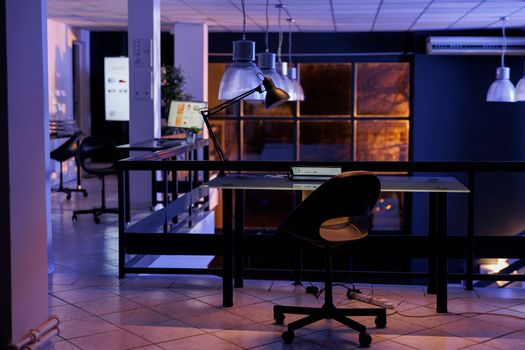 Interior of empty business office with modern furniture during night time