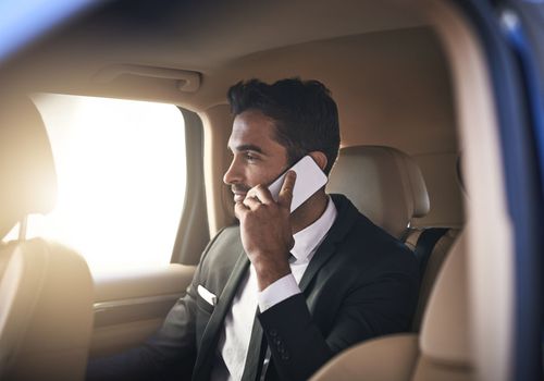 Business doesnt have to be confined to the office. a handsome young businessman making a phonecall while on his morning commute to work.