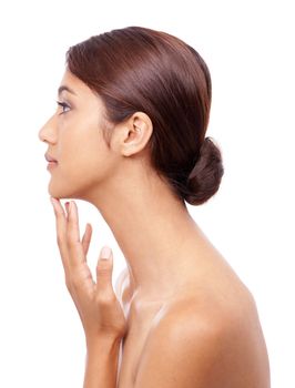 Flawless skin. Profile of a beautiful young woman touching her chin.
