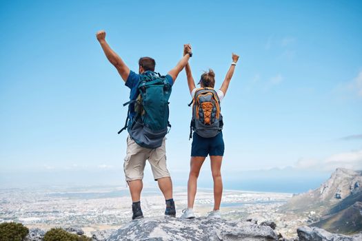 Success, hiking and couple holding hands on mountain for celebration, motivation and freedom on travel in Costa Rica. Back of happy, excited and trekking man and woman celebrate adventure on a cliff