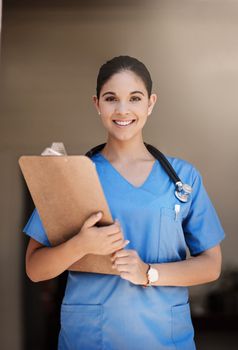 Let me guide you with your health concerns. Cropped portrait of an attractive young female medical practitioner holding a clipboard in a hospital.
