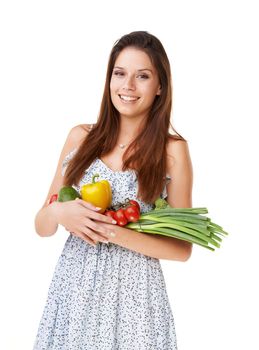 Stocking up on some fresh veggies. Portrait of a beautiful young woman holding a bunch of vegetables.