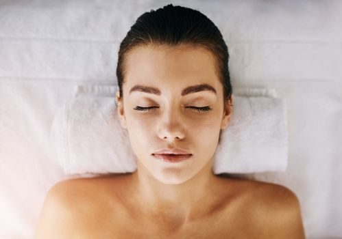 I can just lay here all day. Closeup shot of a young woman relaxing on a spa bed