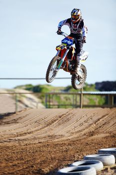 On his way to becoming a champion. A motocross rider mid-air during a jump.