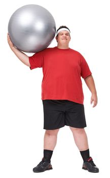 At least I can lift this. A full length portrait of a young man exercising with a swiss ball.