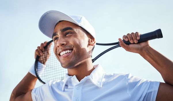 I think Ive got my swing sorted. a handsome young man standing and holding a tennis racket during practice.