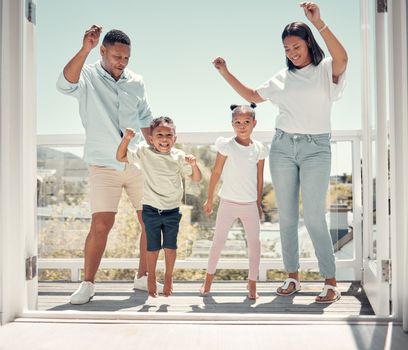 Happy family dancing, couple and kids on balcony of home having fun in celebration of summer life. Mother, father and children dance together to celebrate weekend in new apartment with happy energy.
