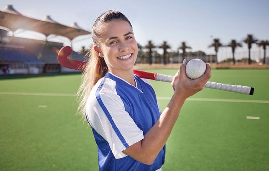 Sports, hockey and woman at a stadium for fitness, training and game practice, happy and proud. Field hockey, coach and sport leader portrait of lady holding a ball before endurance match on a field