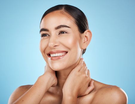 Woman, face and smile, happy and facial with natural cosmetics and beauty isolated against blue background. Clean, cosmetic care and hands with glow, makeup and healthy skin with skincare in studio