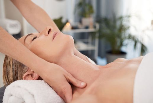 You should feel all the tension escape your body. a mature woman enjoying a relaxing massage at a spa.