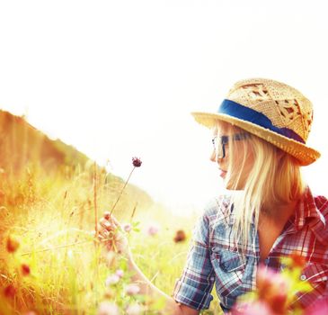 Life is beautiful. Beautiful young hipster in a field - lomo-style photography.