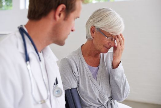 Growing older comes with some tough realities. a senior woman responding to bad news from her doctor.