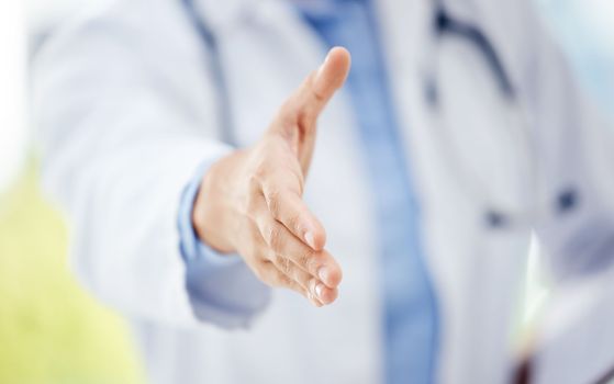 Here to guide you through it all. Closeup shot of an unrecognisable doctor extending a handshake in a hospital.
