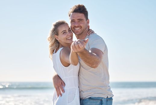 Couple, portrait smile and hug on the beach for love, care or romantic bonding together in the outdoors. Happy man and woman smiling in happiness for summer vacation or relationship romance by ocean.