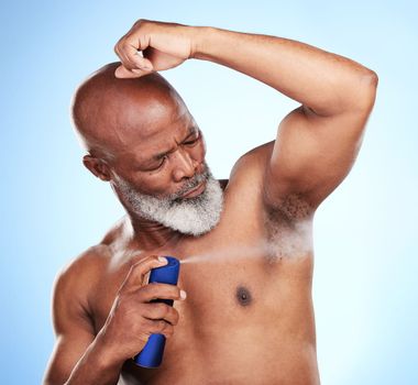 Youve gotta smell your best every day. a handsome mature man posing in studio against a blue background.
