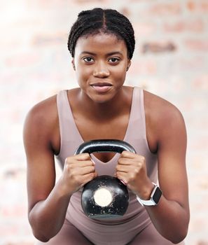 Exercise, workout and black woman with kettle ball for strength, health or wellness. Sports, fitness and face portrait of female athlete from Nigeria with weight for lifting, training and exercising.