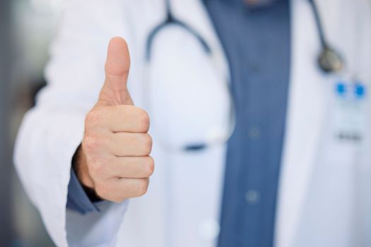 Winner, success and doctor thumbs up at hospital for agreement, achievement or thank you. Healthcare, cardiology and professional medical man approval, ok or vote in medicare career.