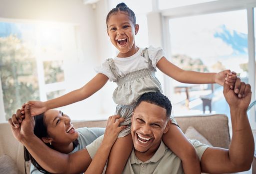 Happy family, smile and piggyback playing on sofa for quality bonding or relaxing together at home. Mother, father and child smiling for joy in playful fun and family time on the living room couch