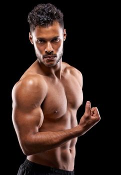 Look at that bump. Studio portrait of a handsome bare-chested young athlete flexing his muscles.