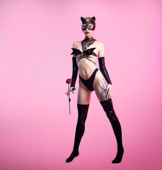Sexy girl in underwear bdsm leather mask sex games costume on pink bright background copy paste
