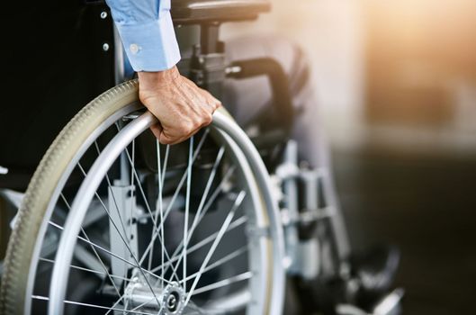 Lets get moving. Closeup shot of an unrecognizable man sitting in a wheelchair.
