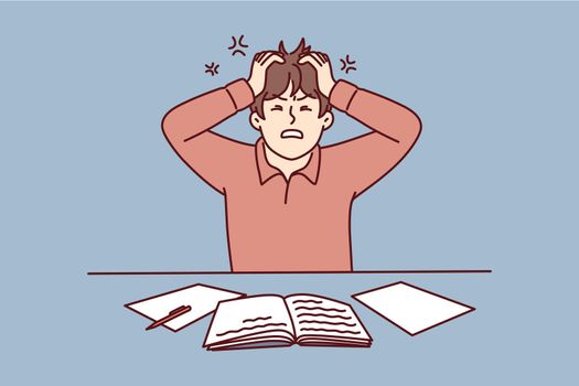 Angry man clutching head sitting at table with workbooks suffering from nervous work. Vector image