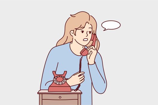 Young woman talk on landline phone