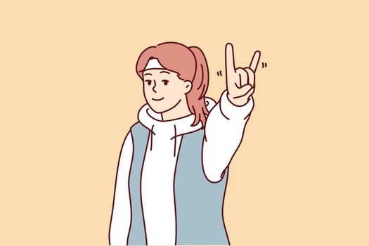 Young woman showing goat gesture demonstrating love for rock and roll to music. Vector image