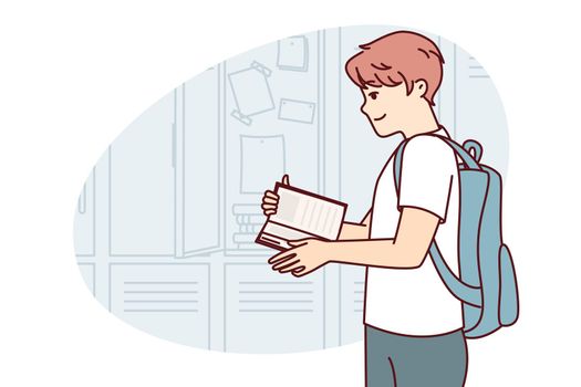 Teenager guy with book and backpack behind back stands near lockers in college room. Vector image