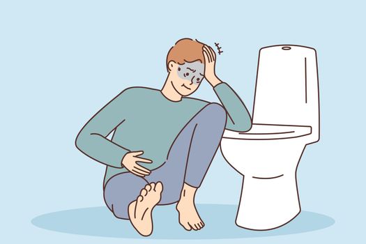 Unhealthy man suffer from intoxication near toilet