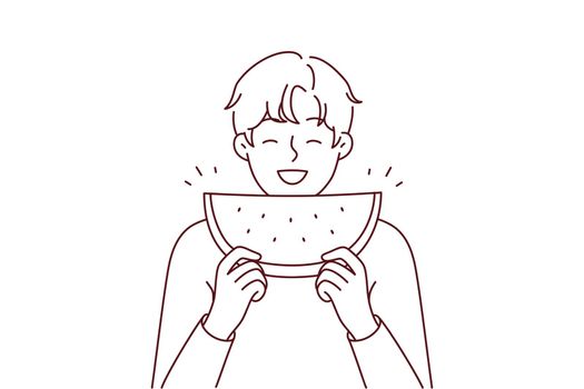 Smiling man eating watermelon