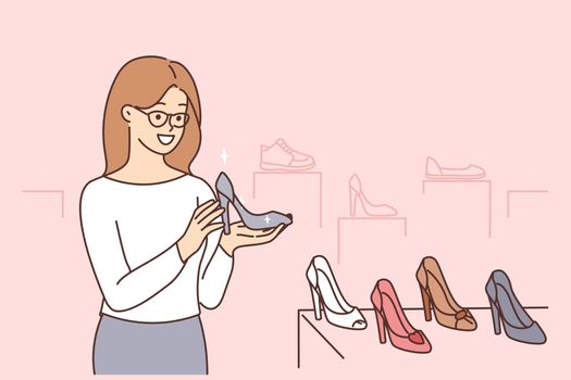 Smiling woman choosing heels in shop