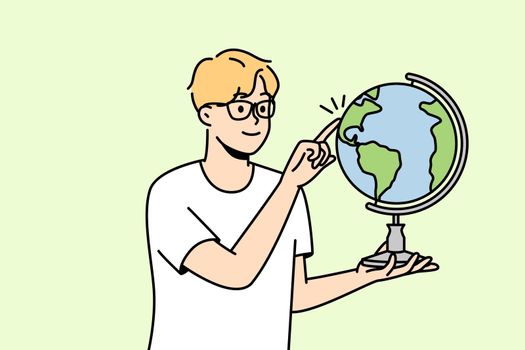 Guy in glasses spin globe
