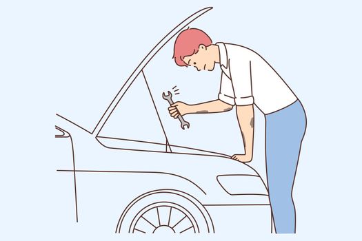 Young man repair car with tool
