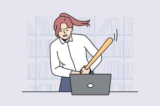 Furious businesswoman crash computer with bat
