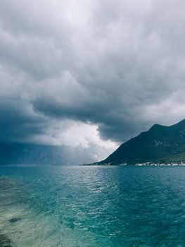 Dark stormy sky over the sea and mountains