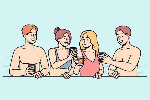 Girls, guys drink cocktails in swimming pool in summer.